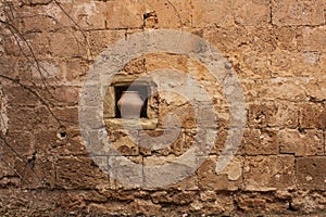 Medieval walls of the Cathedral with a pot of water